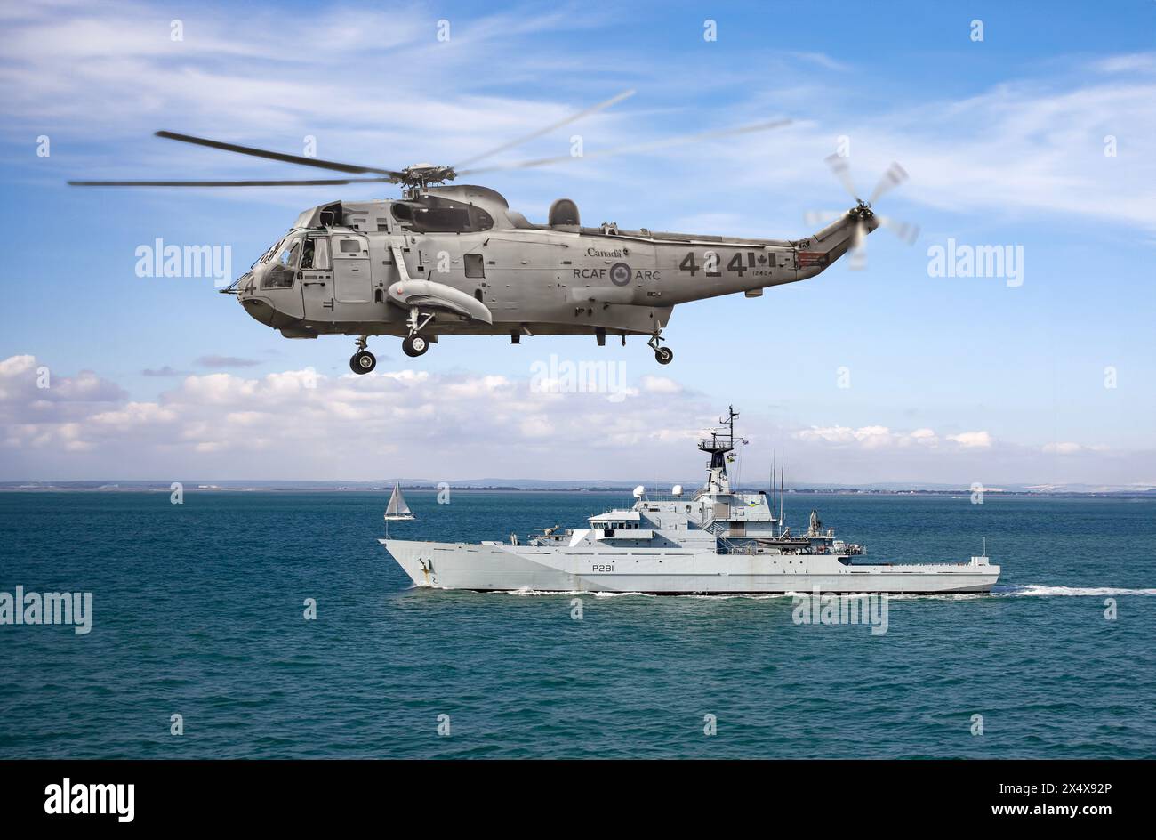 Canadian navy Sea King helicopter over HMS Tyne in the Solent UK Stock Photo