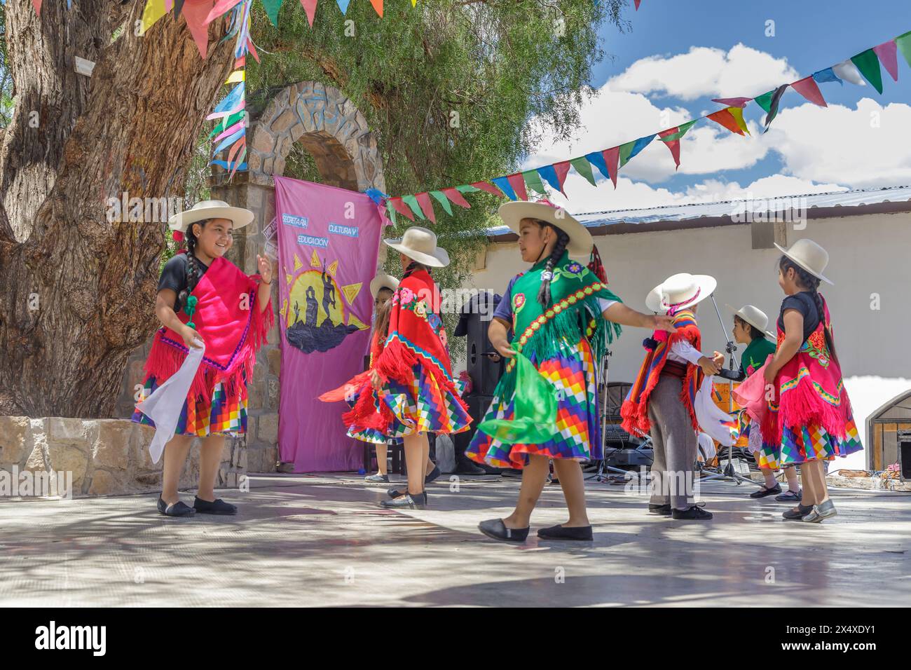 Jujuy, Argentina - January 25th 2024: Boys and girls in traditional Altiplano clothing dancing. Stock Photo