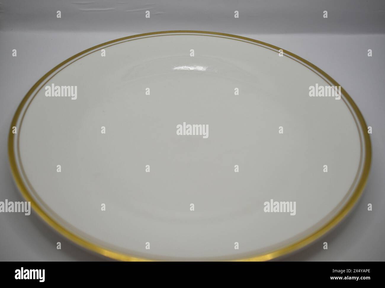 White dinner plate with gold rim stock photo alamy