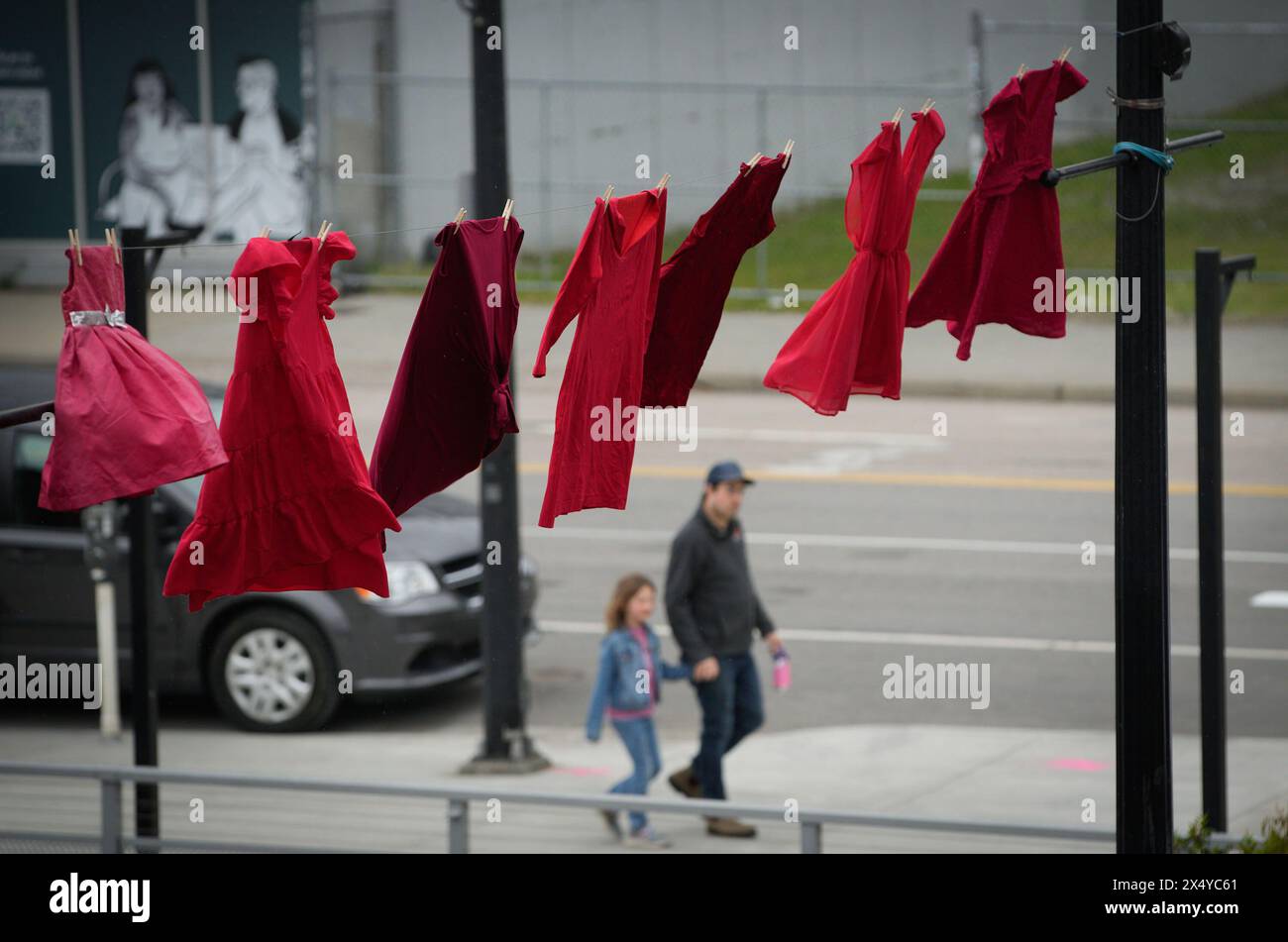 New Westminister, Canada. 5th May, 2024. Red dresses are hung along a street to mark the National Day of Awareness for Missing and Murdered Indigenous Women and Girls in New Westminster, British Columbia, Canada, on May 5, 2024. May 5 is the National Day of Awareness for Missing and Murdered Indigenous Women and Girls, also known as Red Dress Day, in Canada. Credit: Liang Sen/Xinhua/Alamy Live News Stock Photo