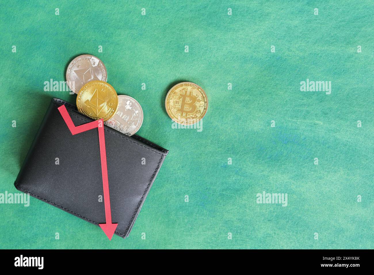 A black wallet with bitcoin and downward red arrow. Cryptocurrency bear run and price decrease concept. Stock Photo