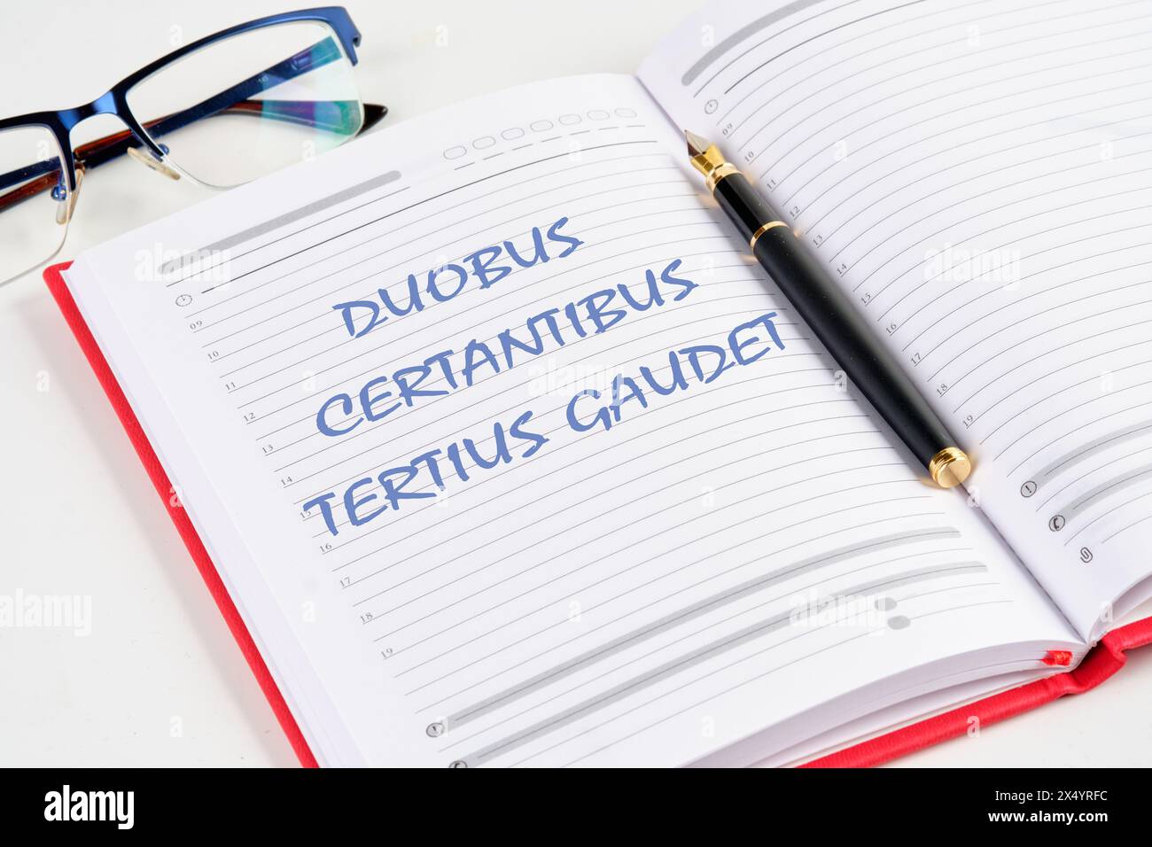 DUOBUS CERTANTIBUS TERTIUS GAUDET it means in Latin While two argue, the third rejoices. the inscription in the notebook Stock Photo
