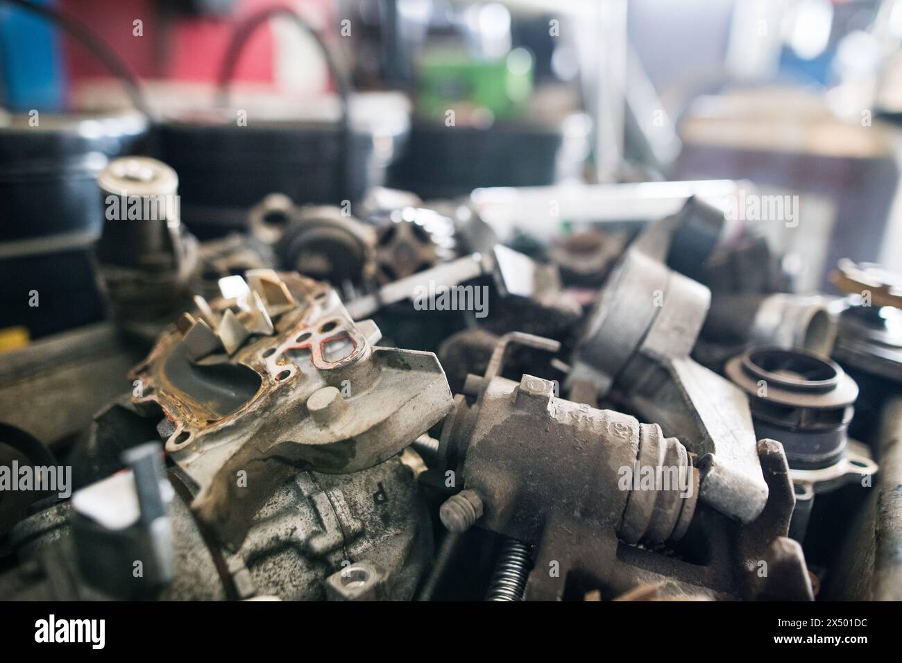 Metal components on workbench in auto repair shop. Mechanics repairing ...