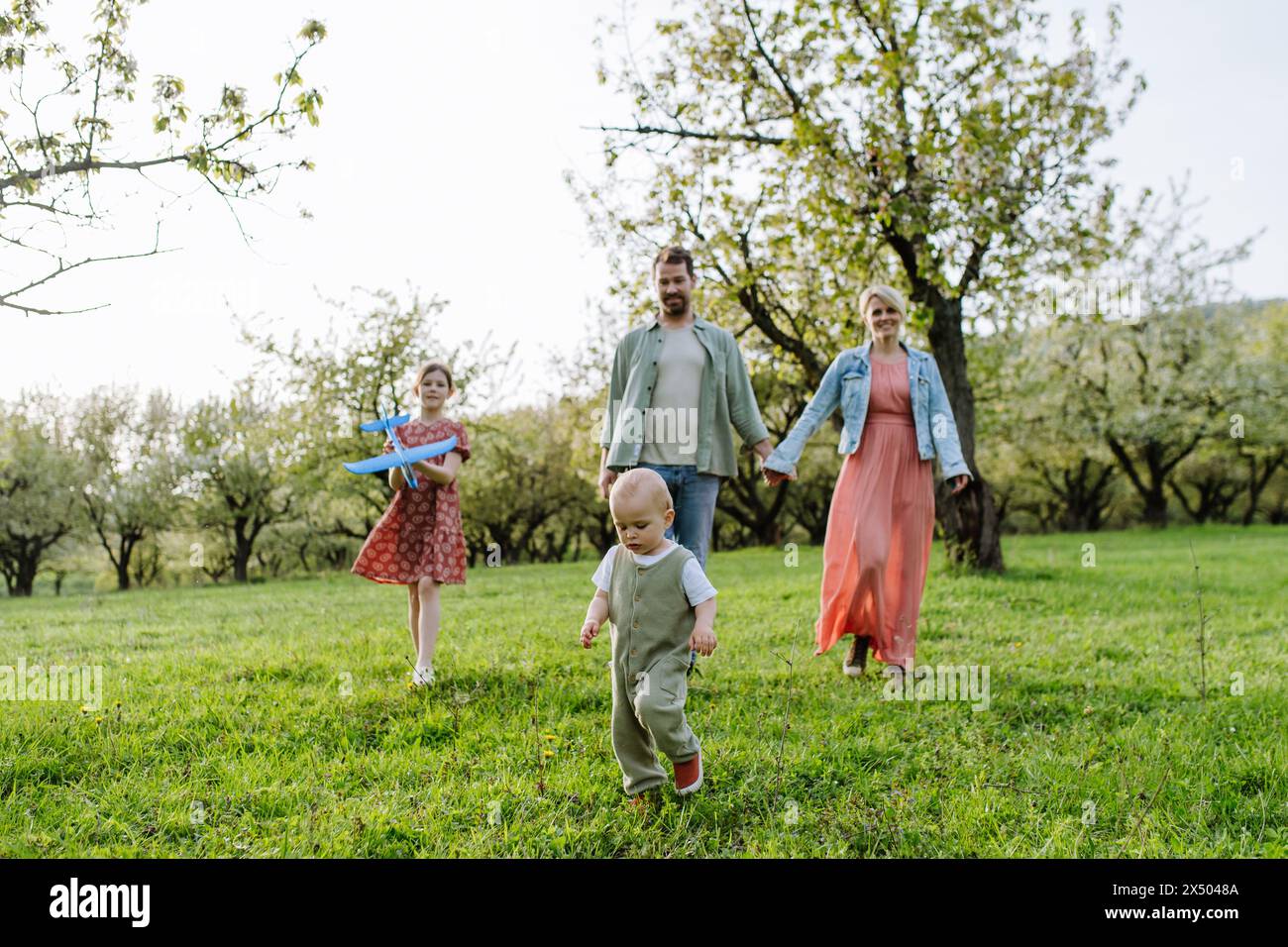 Happy family four walking hi-res stock photography and images - Alamy