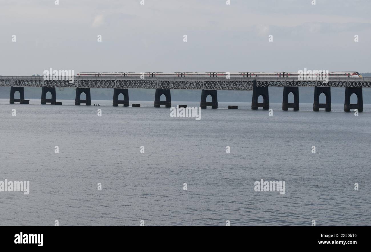 A London-bound LNER train crossing the Tay Bridge, leaving Dundee, Scotland. Stock Photo