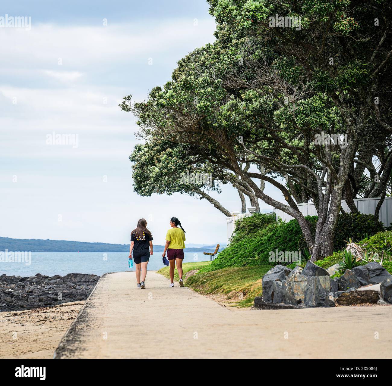 Women walking on Milford Beach. Auckland. Stock Photo
