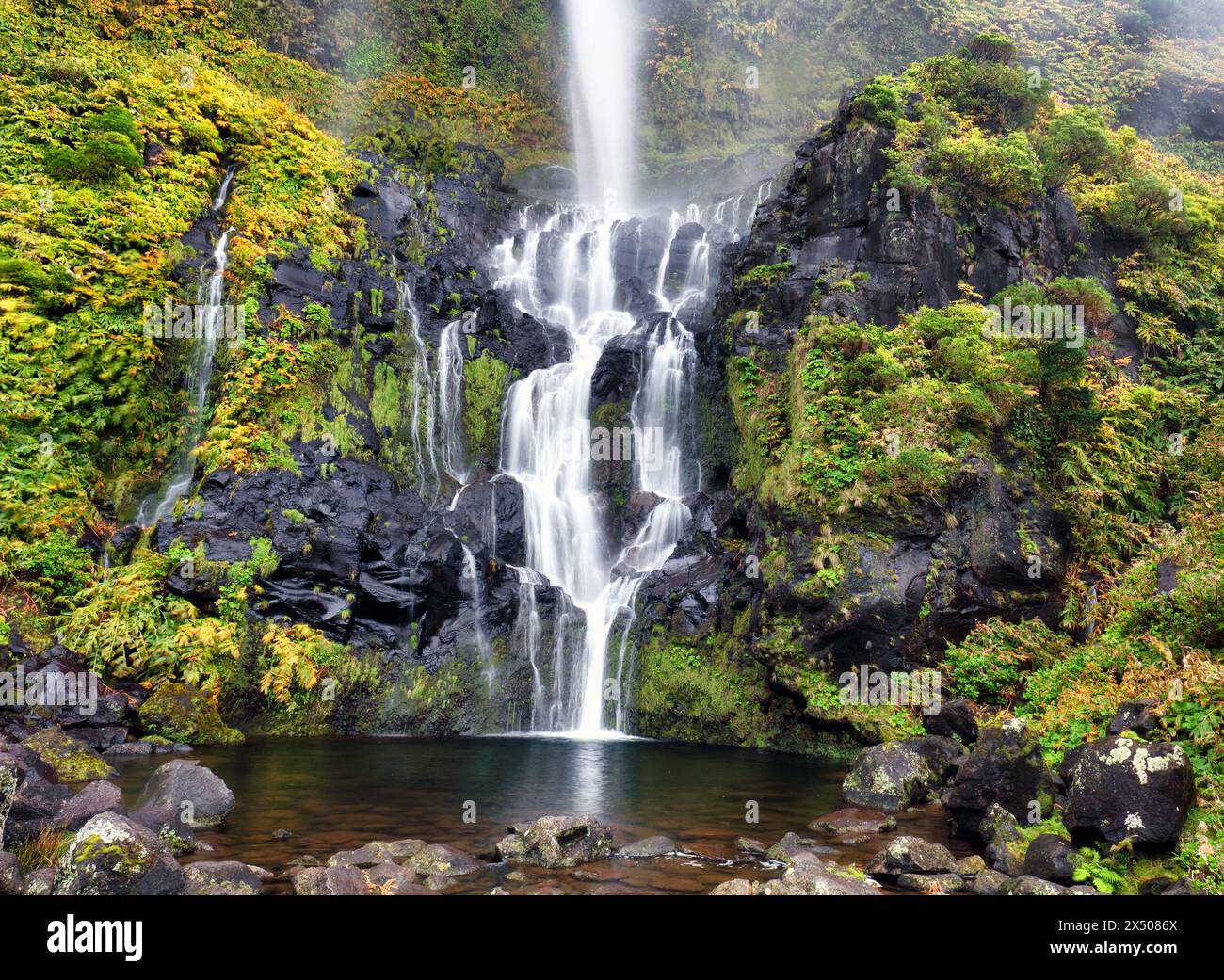 The Poço do Bacalhau waterfall in the Flores island of Azores. Green