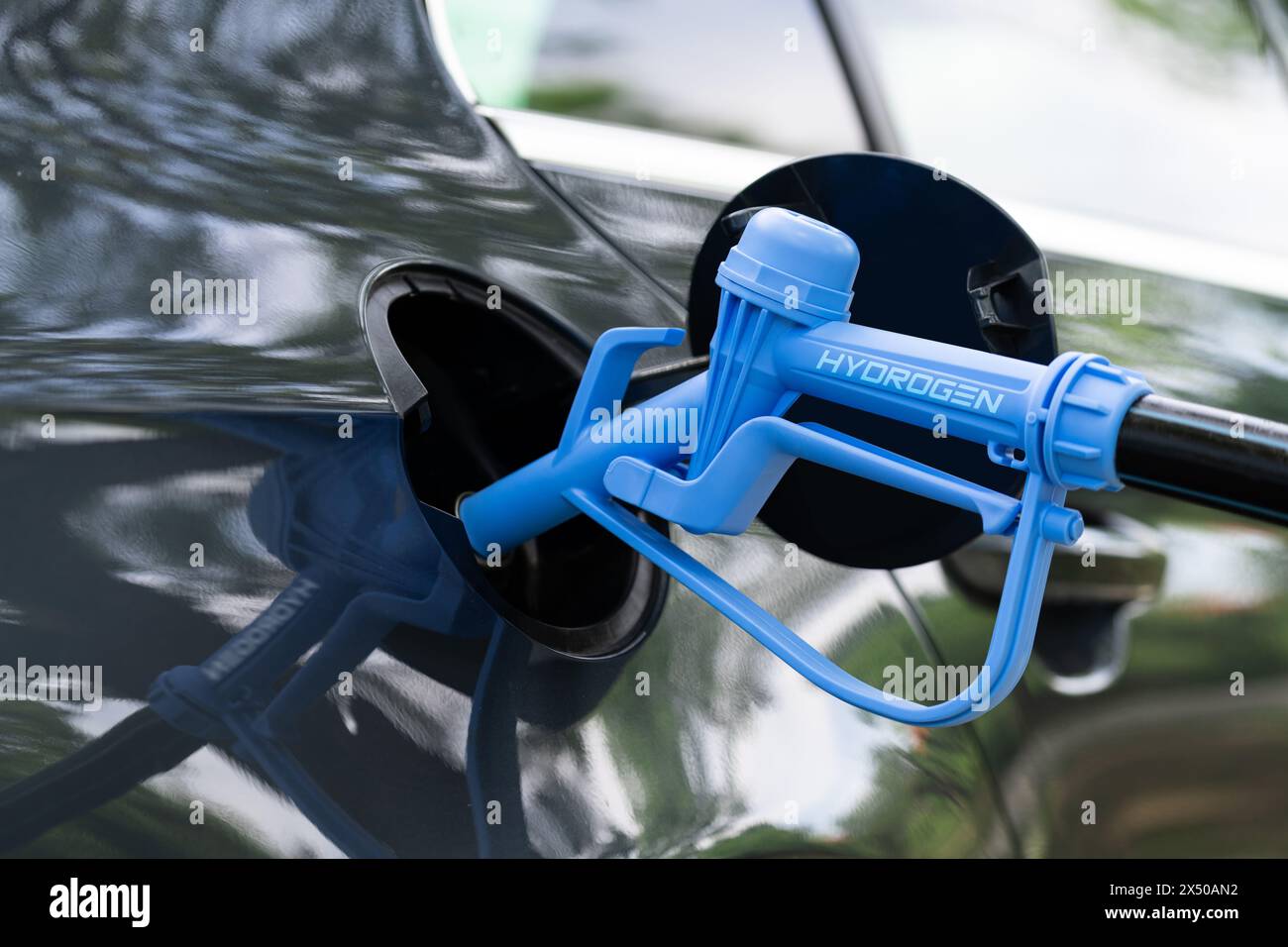 Close up of fuel cell car with connected hydrogen fueling nozzle Stock Photo