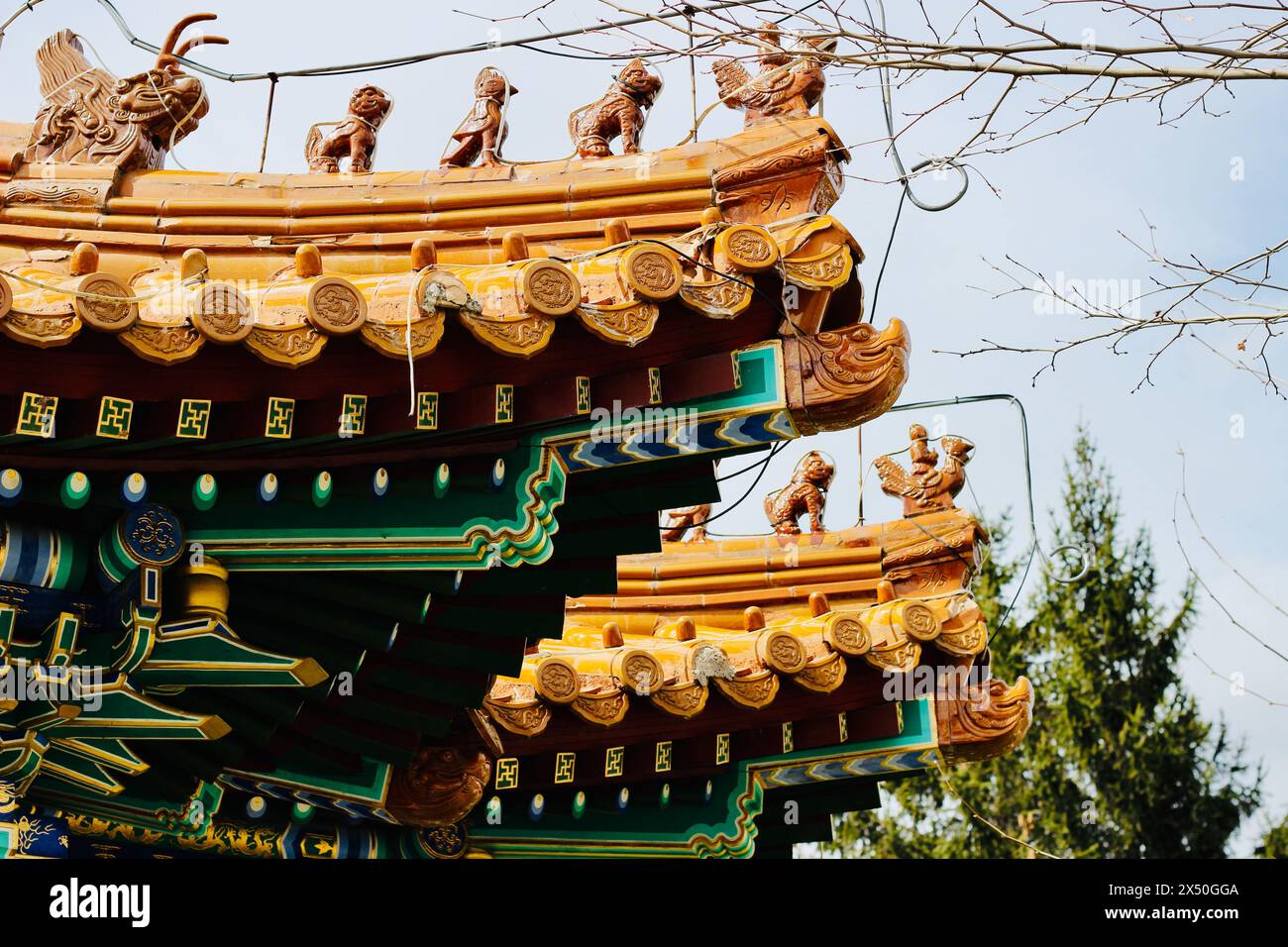 Golden Chinese Rooftop Close-up of a traditional golden Chinese pavilion rooftop with ...