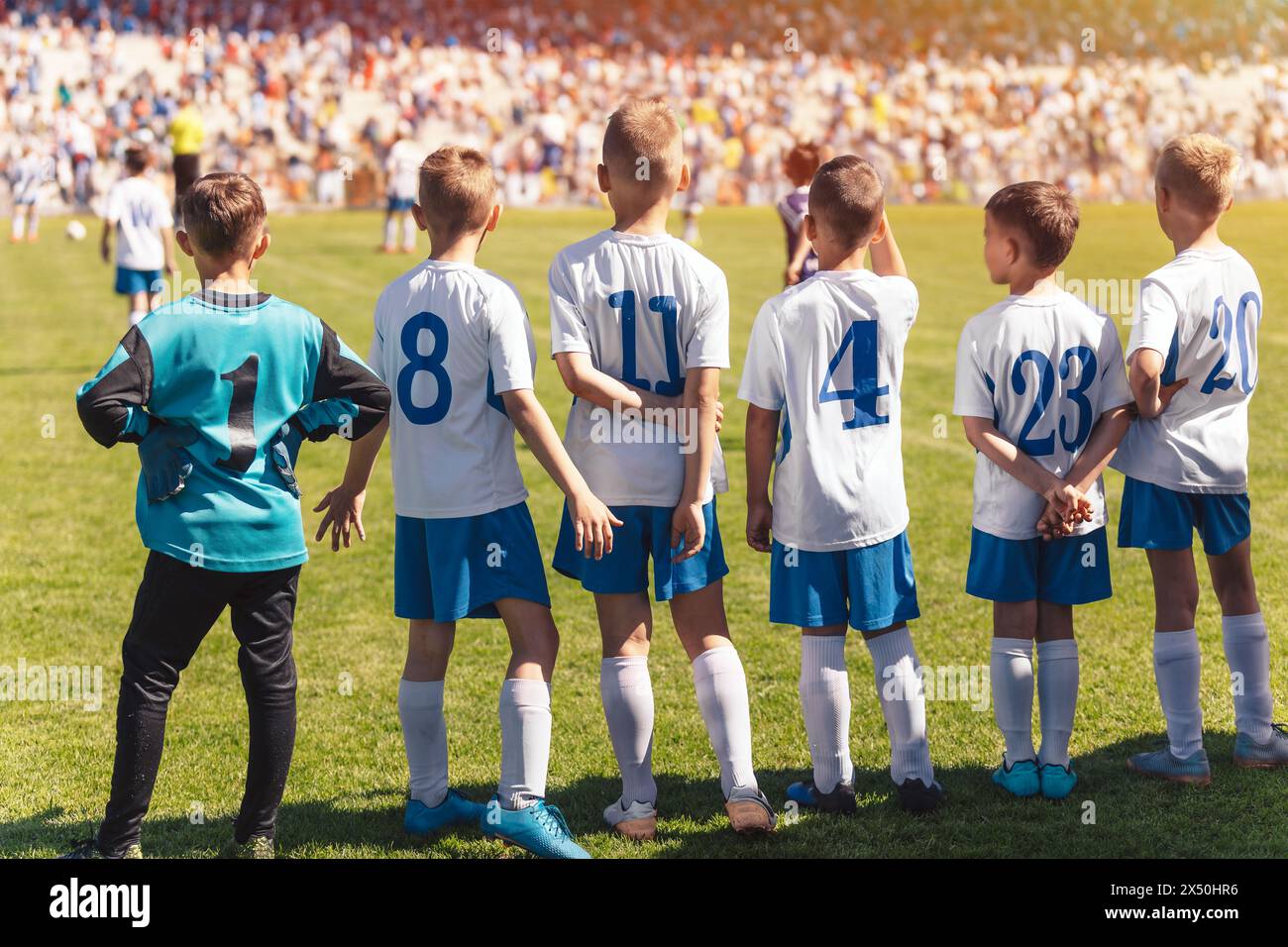 Football Academy Youth Team. Group of Soccer Boys in School Team. Players Watching the Match and Ready To Play the Game. Kids in Soccer Jerseys Play t Stock Photo