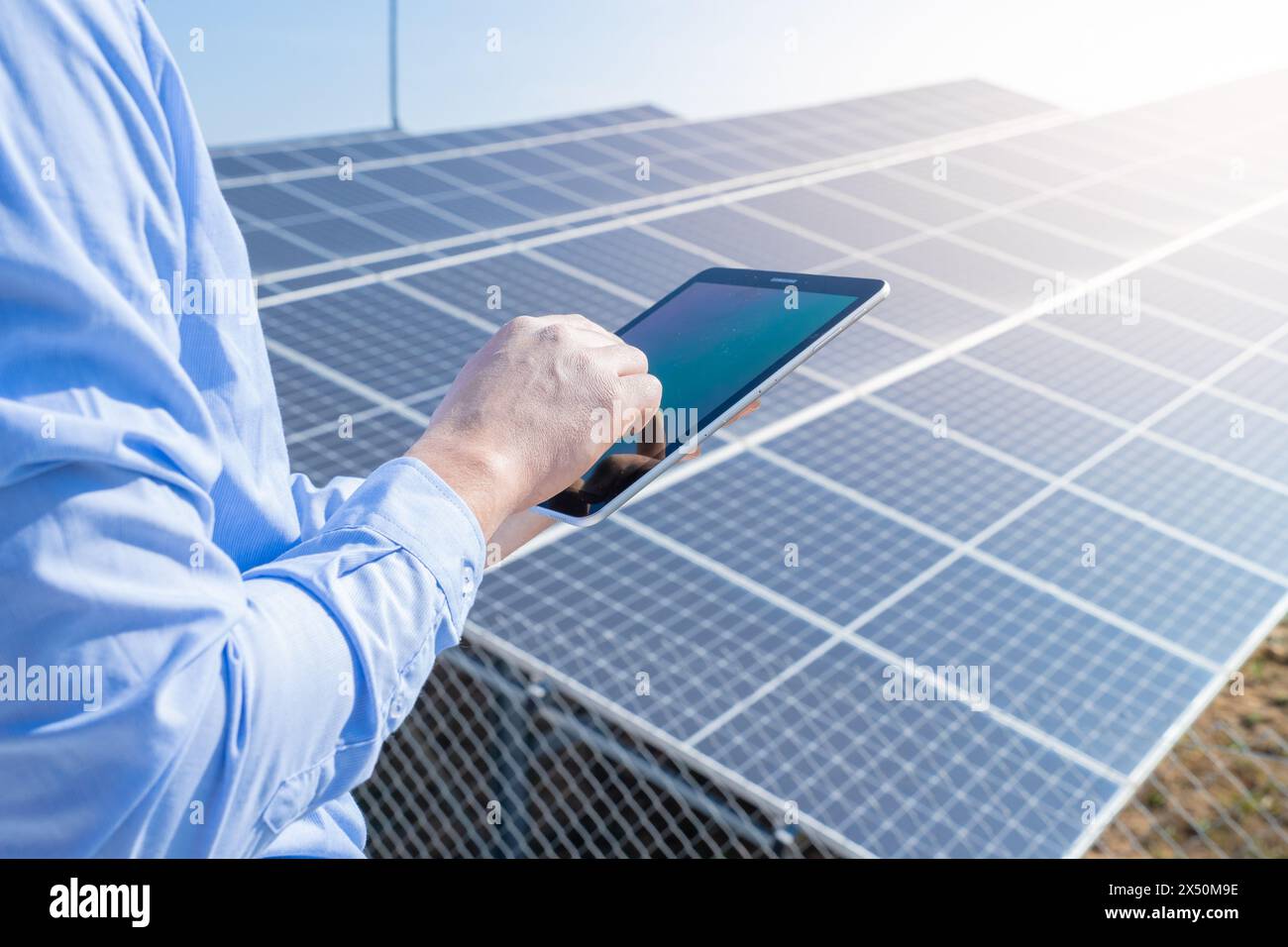 Close-up of a engineer checking solar panel setup. Using smart app in tablet Stock Photo