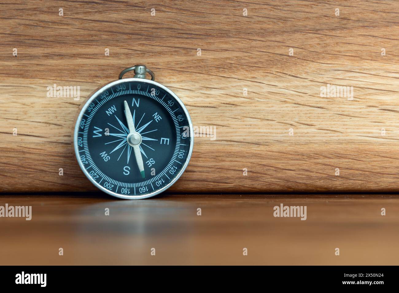Compass on wooden background with copy space using as direction Stock Photo