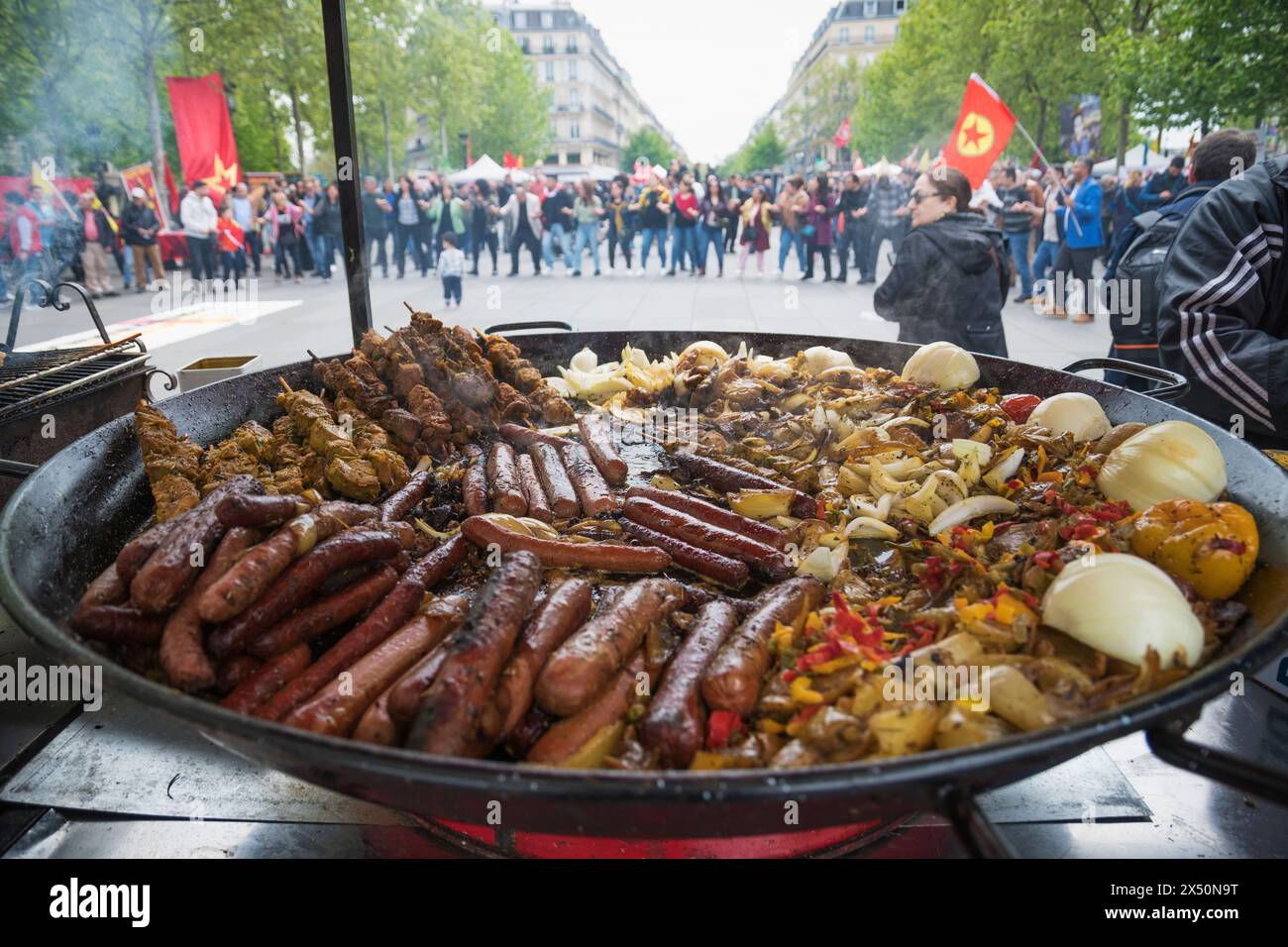 Paris,France,1st of May 2024.Thousands of people protested and celebrated on mayday in Paris.  Labour unions,workers,students and others marched through the streets. Street food Stock Photo