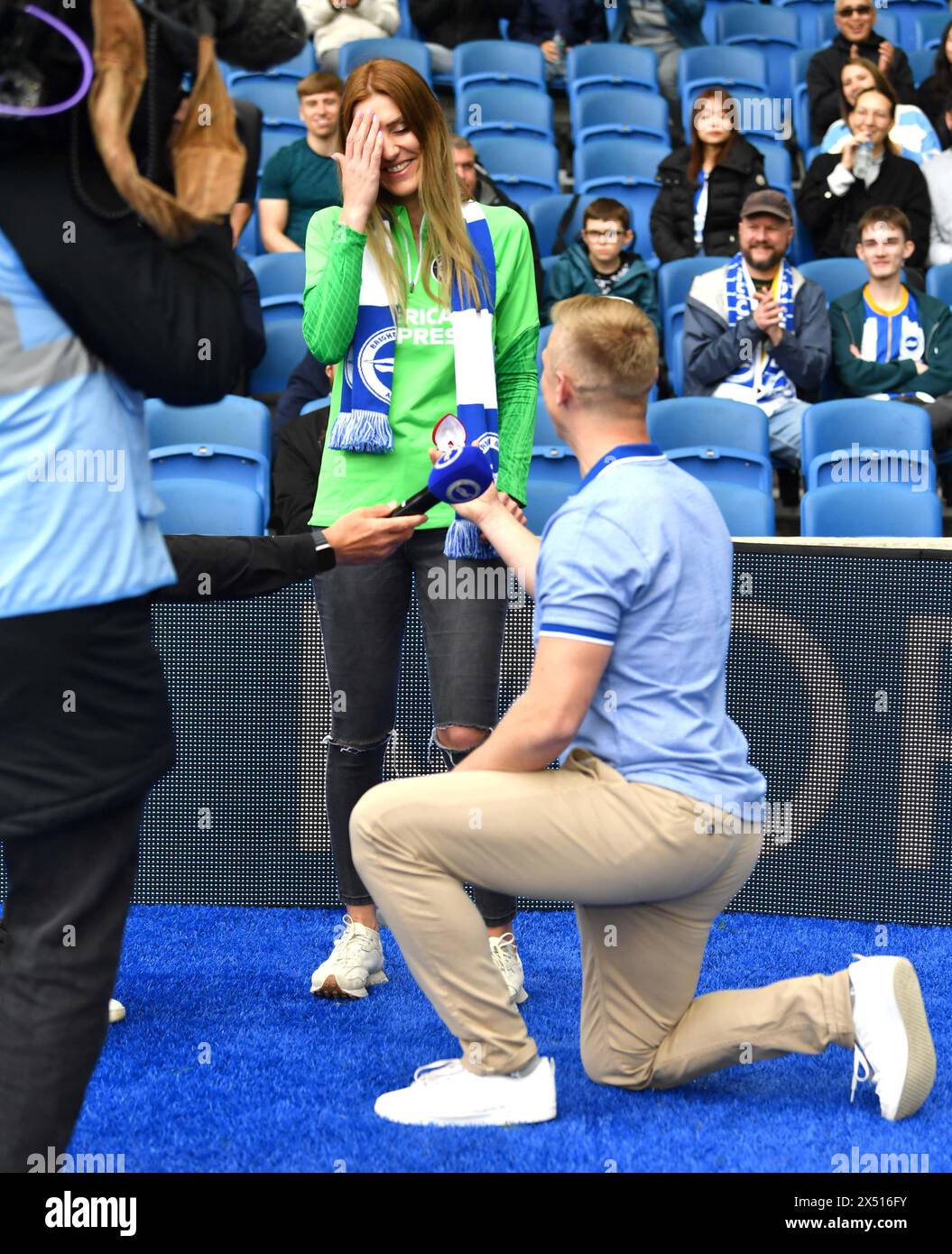 Rafal Ciupinski proposes to Sylwia Kolaczkowska before   the Premier League match between Brighton and Hove Albion and Aston Villa at the American Express Stadium  , Brighton , UK - 5th May 2024 Stock Photo