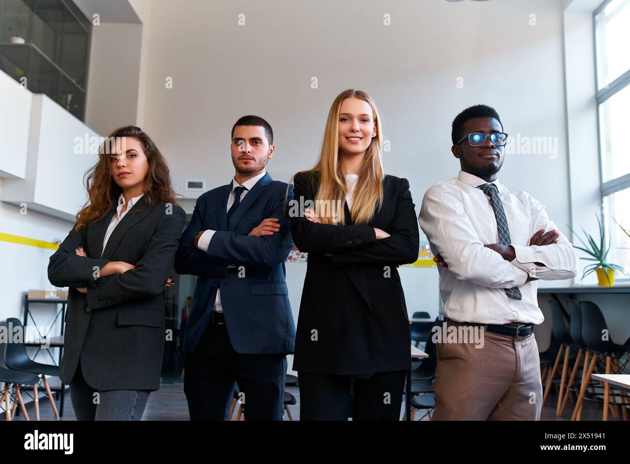 Confident multiracial business team stands in office space, female CEO ...