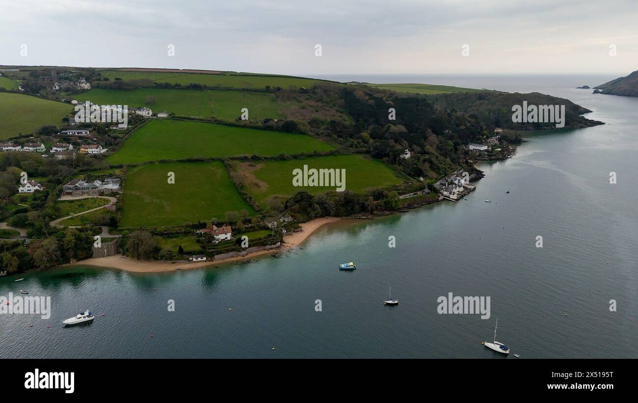 Drone, aerial view, of East Portlemouth taken from vicinity of Snapes Point on a clear spring day - view along the estuary to sea showing Sharp Tor Stock Photo