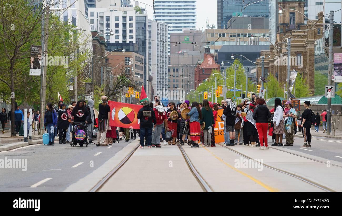 A group of people including First Nations march in support of the