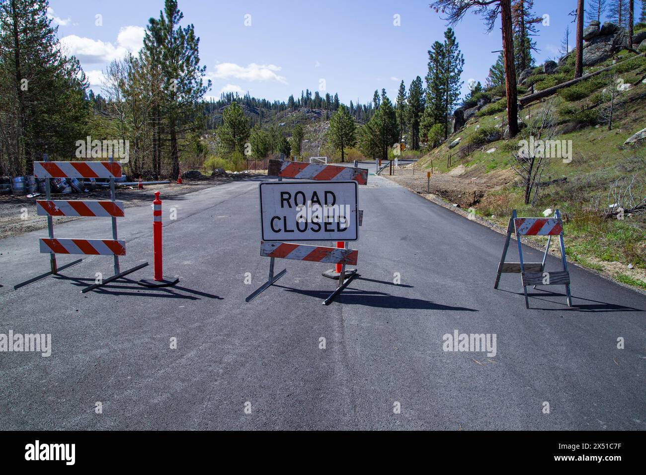 Baracades and signage mark a road closure in the Plumas National Forest