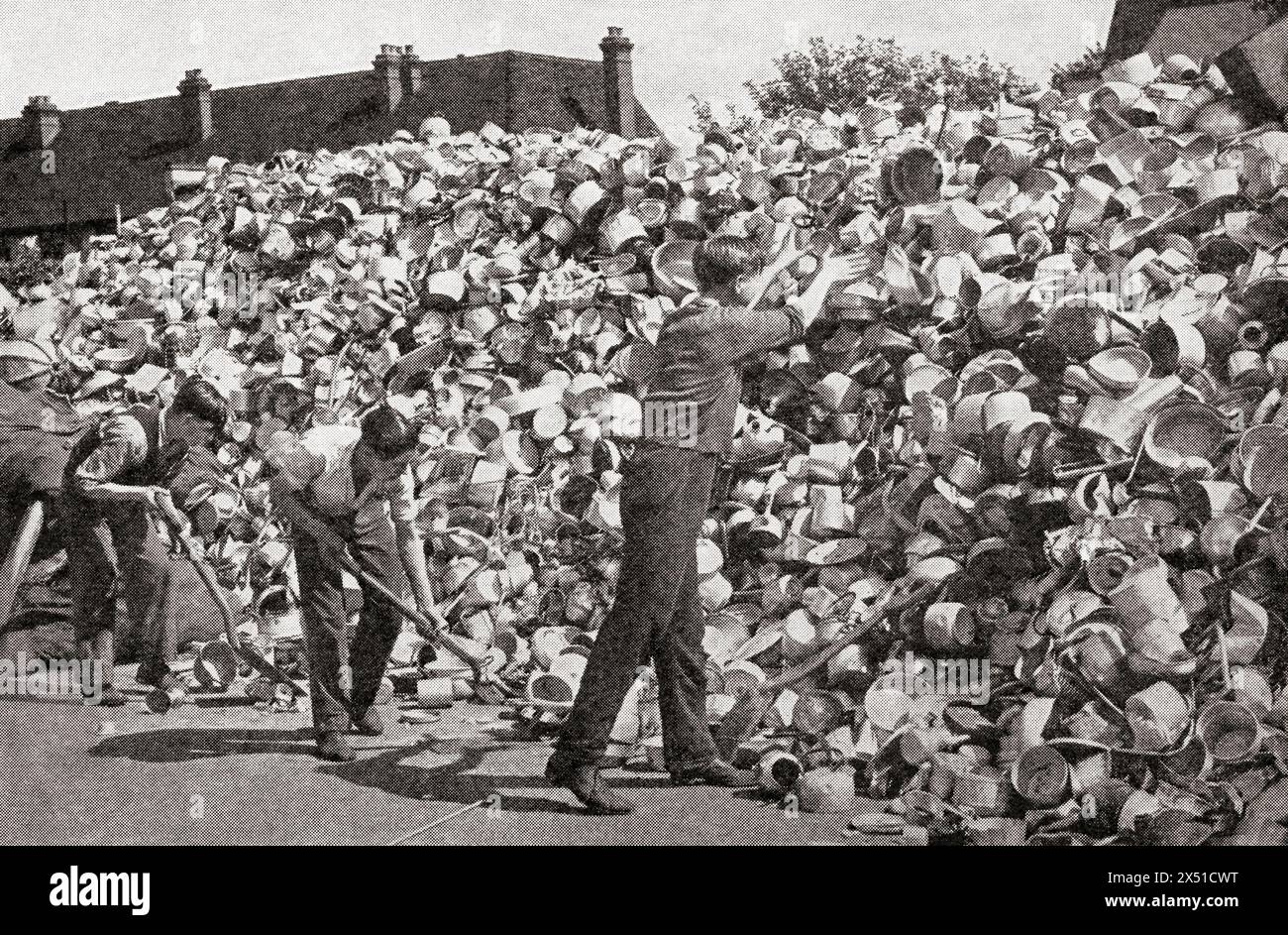 In 1940 Lord Beaverbrook, minister of aircraft production, appealed for aluminium from the women of England to help the war effort, seen here are pots and pans donated to one of the aircraft factories.  From The War in Pictures, First Year. Stock Photo