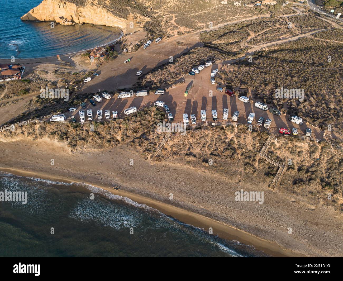 Aguilas, Spain; May 1st 2024: Motor homes and camper vans parked at Playa de la Carolina beach in Cuatro Calas, Aguilas, Murcia Stock Photo
