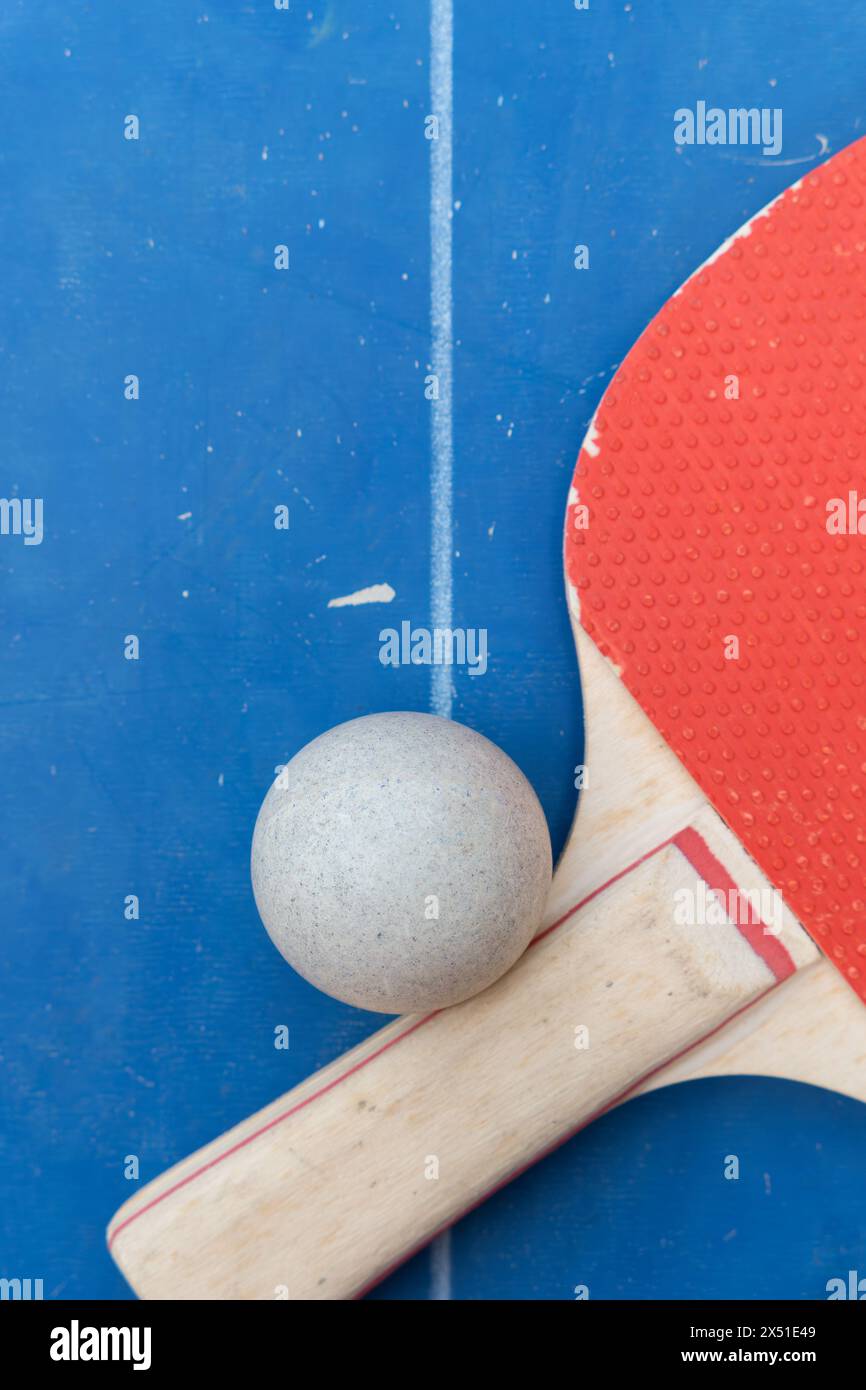 top view pingpong racket and ball on a blue pingpong table at vertical composition Stock Photo