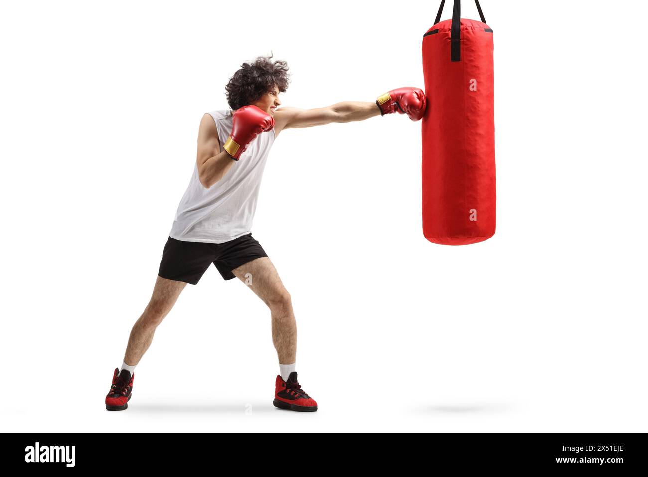 Young man punching a boxing bag isolated on white background Stock Photo