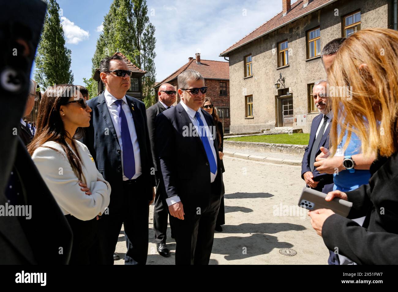 Yoav Kisch, Minister of Education of Israel (C) visits exhibitions as he arrive for the March of the Living at Auschwitz Camp gate 'Work Makes you Free' with 55 holocaust survivors on May 06, 2024 in O?wi?cim, Poland. Holocaust survivors, and October 7th survivors attend the March of the Living together with a delegation from, among others, the United States, Canada, Italy, United Kingdom. On Holocaust Memorial Day observed in the Jewish calendar (Yom HaShoah), thousands of participants march silently from Auschwitz to Birkenau. The march has an educational and remembrance purpose. This year Stock Photo