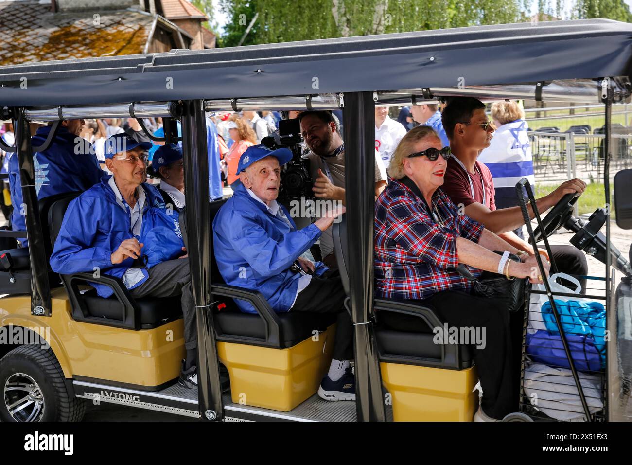 Elderly Holocaust survivors are being driven for the March of the Living 2024 at Auschwitz Camp gate 'Work Makes you Free', with 55 holocaust survivors participating, on May 06, 2024 in O?wi?cim, Poland. Holocaust survivors, and October 7th survivors attend the March of the Living together with a delegation from, among others, the United States, Canada, Italy, United Kingdom. On Holocaust Memorial Day observed in the Jewish calendar (Yom HaShoah), thousands of participants march silently from Auschwitz to Birkenau. The march has an educational and remembrance purpose. This year March was highl Stock Photo