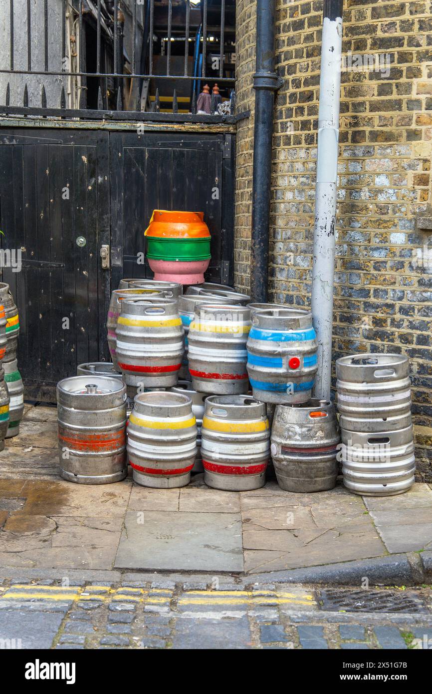 Metal beer kegs stacked on the sidewalk on Rotherhithe Street at the Mayflower Pub in London. Stock Photo