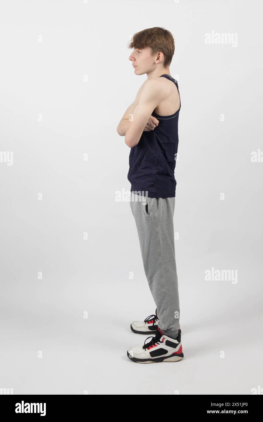 Staning A Fifteen Year Old Teenage Boy Standing Against A White Background In A ...