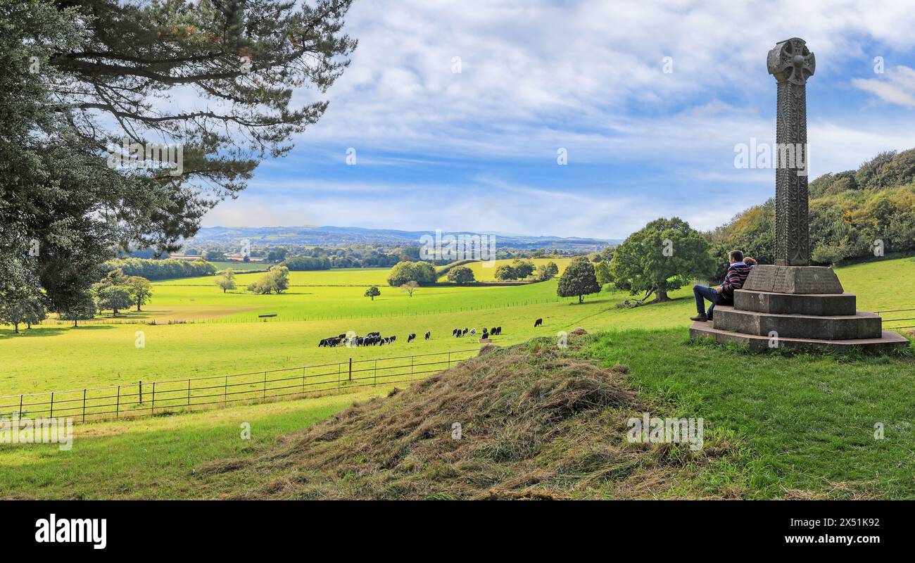 A granite cross in memory of Sir Thomas Dyke Acland, Xth baronet, was erected at the west end of the garden at Killerton House, Devon, England, UK Stock Photo