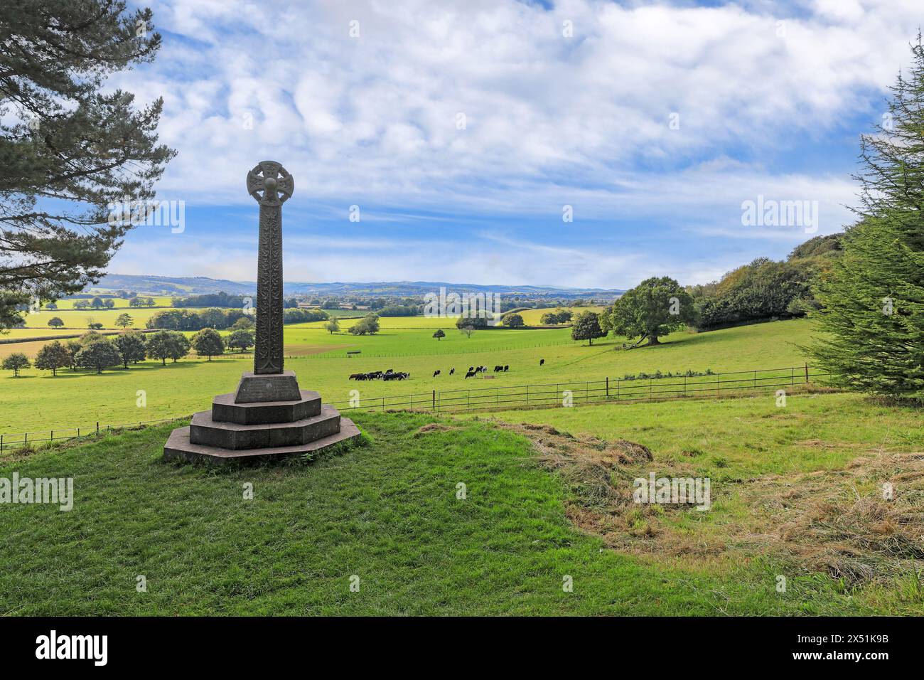 A granite cross in memory of Sir Thomas Dyke Acland, Xth baronet, was erected at the west end of the garden at Killerton House, Devon, England, UK Stock Photo
