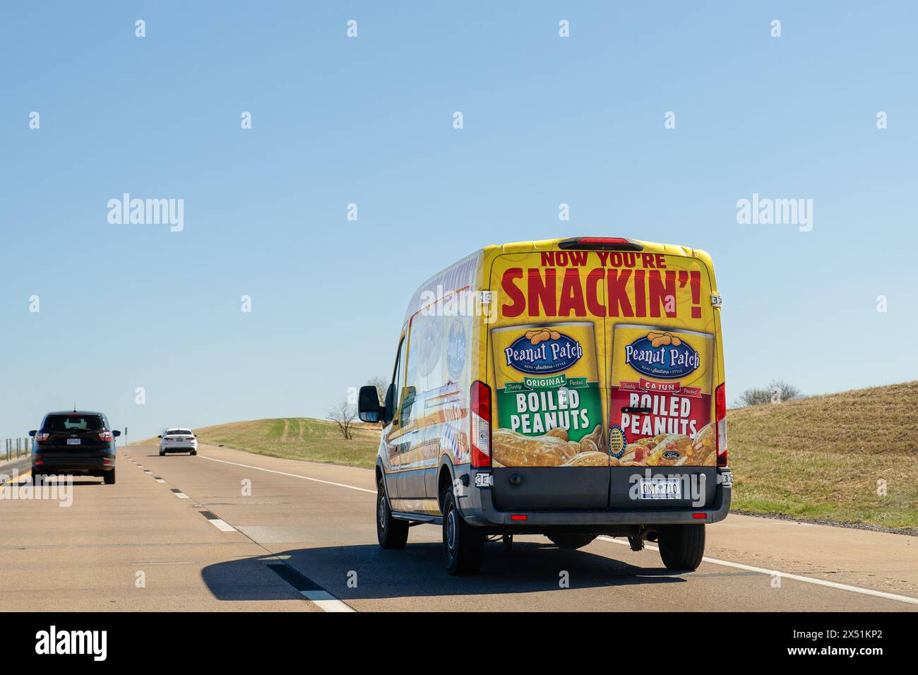 Aledo, Texas - Oct. 16, 2023: Vehicle on the highway with advertisement for Peanut Patch brand "Real Southern Style" Boiled Peanuts. Boiled peanuts ar Stock Photo