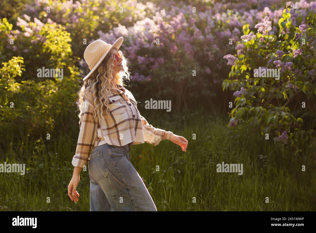 Fashionable girl in flower trees Stock Photo