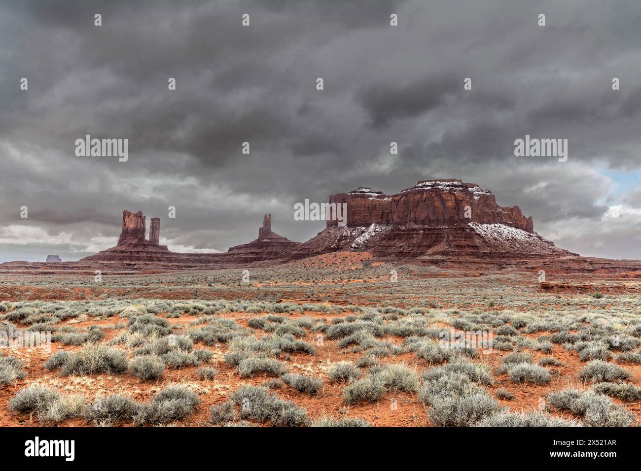 Scenic view of mountainous formations in Monument Valley during a cold, snowy morning while driving in the Navajo park in Arizona. Stock Photo