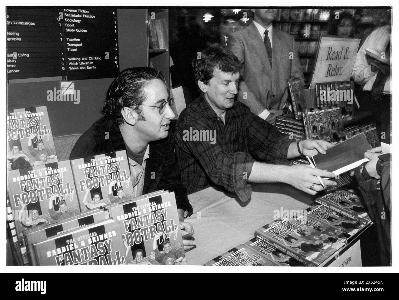 DAVID BADDIEL, FRANK SKINNER, FANTASY FOOTBALL, 1995: David Baddiel and Frank Skinner sign copies of their new book Baddiel and Skinner's Fantasy Football Diary at the peak of their fame at Cardiff Waterstone's, Cardiff, Wales, UK on 6 October 1995. Photo: Rob Watkins. INFO: Baddiel and Skinner's Fantasy Football, a British television show aired in the late '90s and early 2000s, blended humor and football analysis. Hosted by comedians David Baddiel and Frank Skinner, it became a cultural phenomenon, popularizing fantasy football and captivating audiences with its irreverent charm. Stock Photo