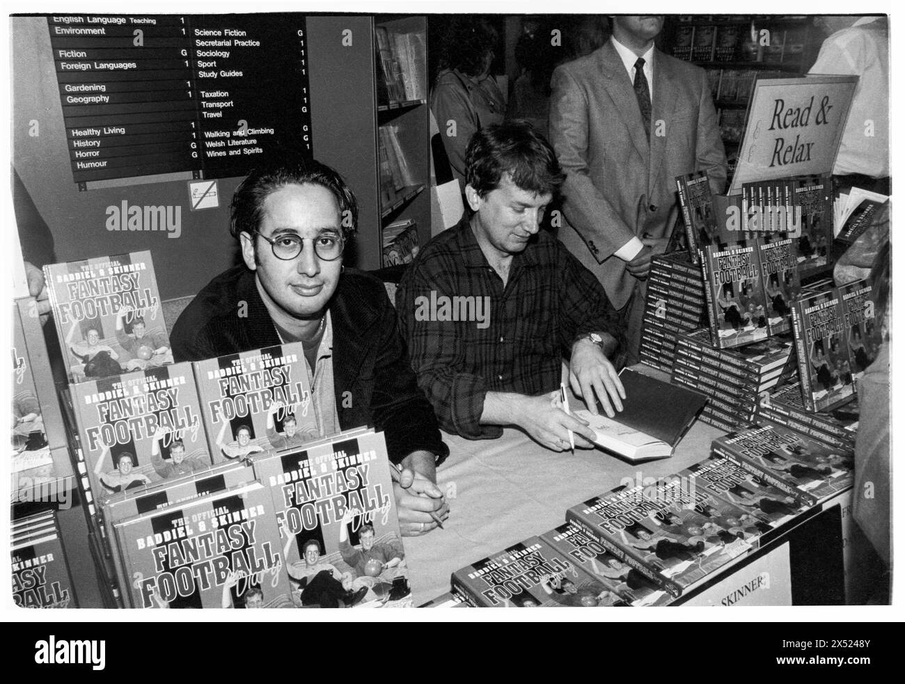 DAVID BADDIEL, FRANK SKINNER, FANTASY FOOTBALL, 1995: David Baddiel and Frank Skinner sign copies of their new book Baddiel and Skinner's Fantasy Football Diary at the peak of their fame at Cardiff Waterstone's, Cardiff, Wales, UK on 6 October 1995. Photo: Rob Watkins. INFO: Baddiel and Skinner's Fantasy Football, a British television show aired in the late '90s and early 2000s, blended humor and football analysis. Hosted by comedians David Baddiel and Frank Skinner, it became a cultural phenomenon, popularizing fantasy football and captivating audiences with its irreverent charm. Stock Photo
