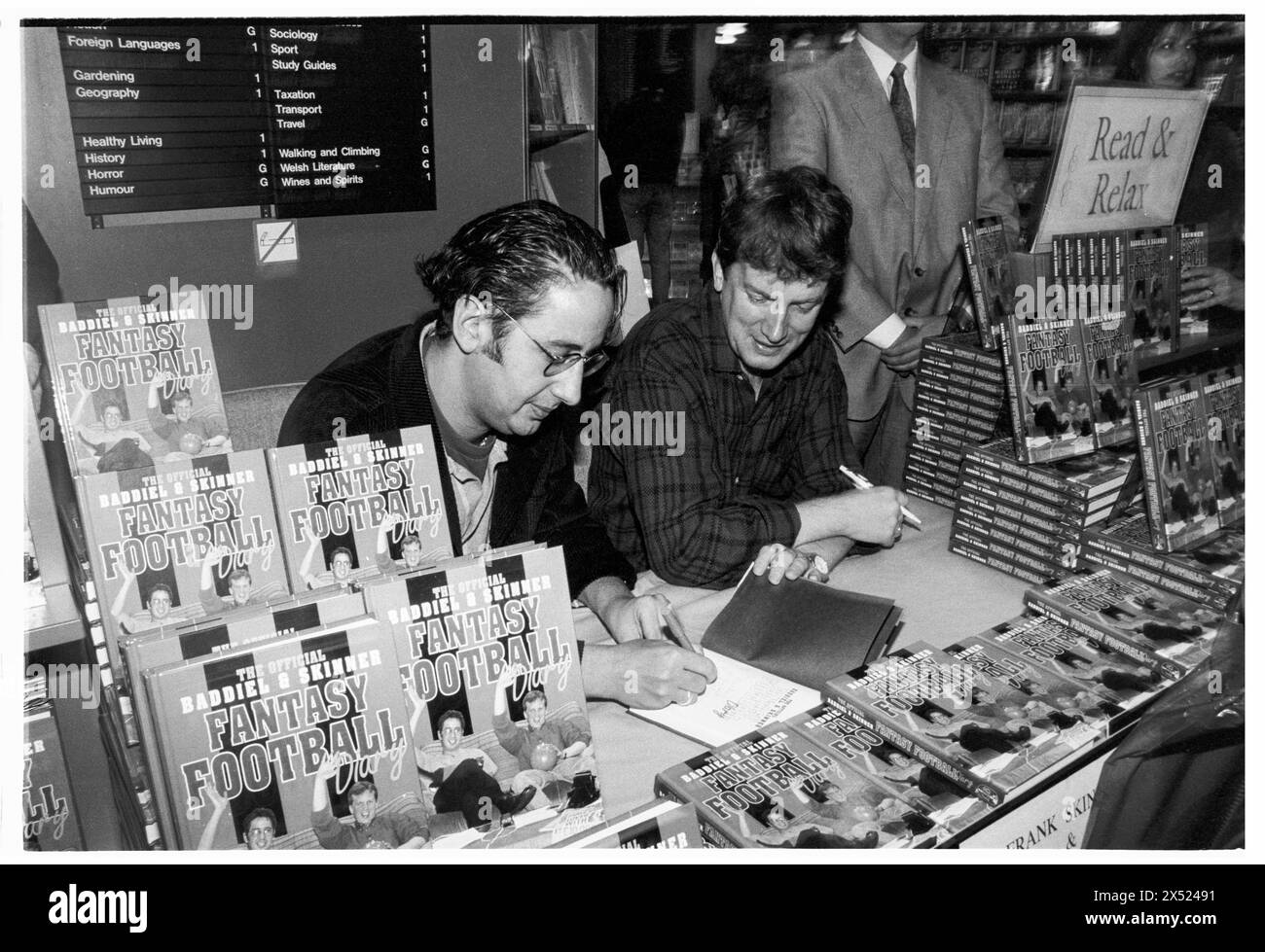 DAVID BADDIEL, FRANK SKINNER, FANTASY FOOTBALL, 1995: David Baddiel and Frank Skinner sign copies of their new book Baddiel and Skinner's Fantasy Football Diary at the peak of their fame at Cardiff Waterstone's, Cardiff, Wales, UK on 6 October 1995. Photo: Rob Watkins. INFO: Baddiel and Skinner's Fantasy Football, a British television show aired in the late '90s and early 2000s, blended humor and football analysis. Hosted by comedians David Baddiel and Frank Skinner, it became a cultural phenomenon, popularizing fantasy football and captivating audiences with its irreverent charm. Stock Photo