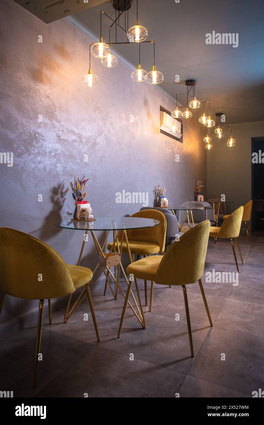Cozy restaurant interior with glass tables, yellow chairs, textured ... - Textured Ceiling With Cozy Lighting
