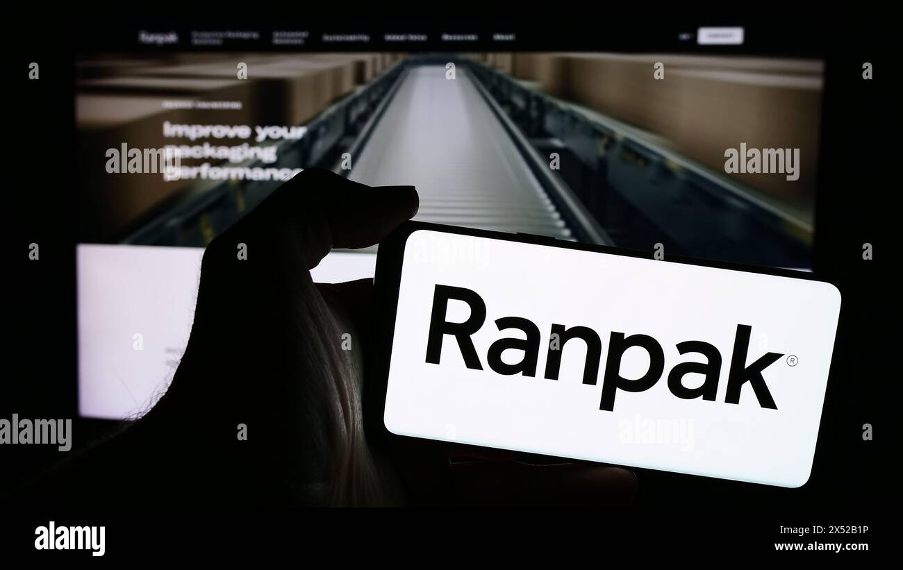 Person holding smartphone with logo of US packaging company Ranpak Holdings Corp. in front of website. Focus on phone display. Stock Photo