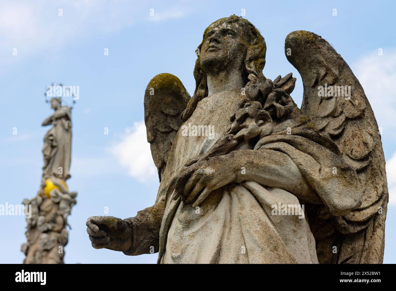 Angel sculpture and Immaculata, featured in baroque monument commemorating plague epidemic of the 1700s. Stock Photo