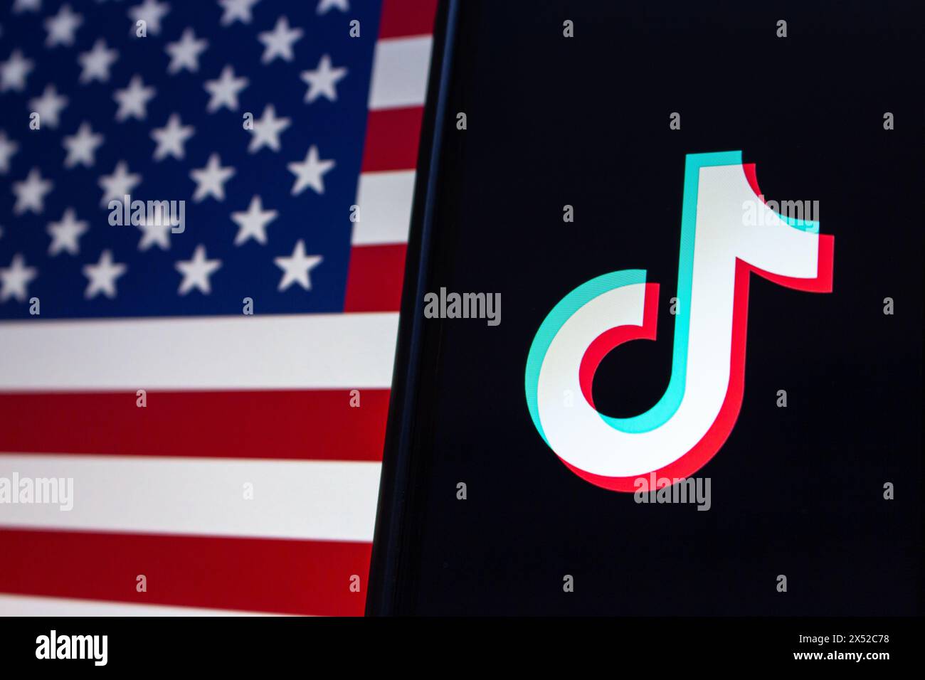 Vancouver, CANADA - Apr 30 2024 : TikTok logo seen in an iPhone screen on American flag  background Stock Photo