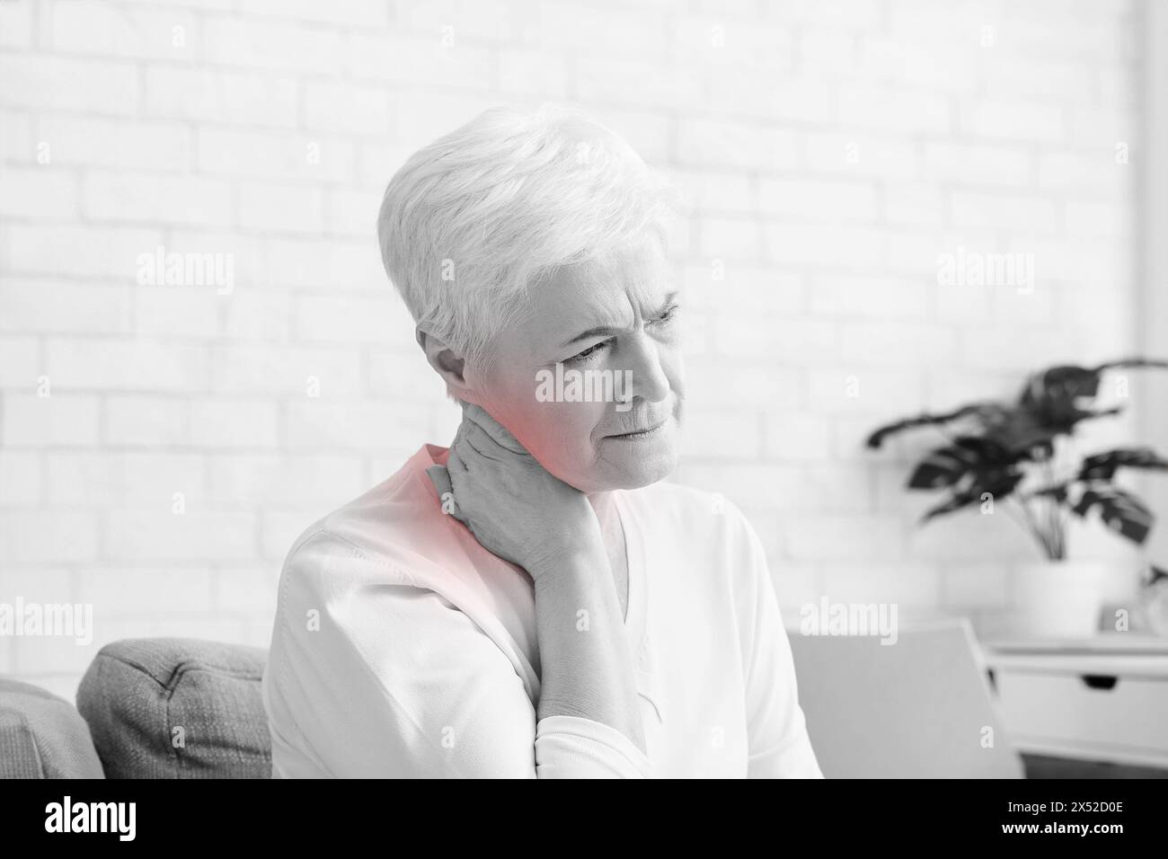 Mature woman suffering from backache at home Stock Photo