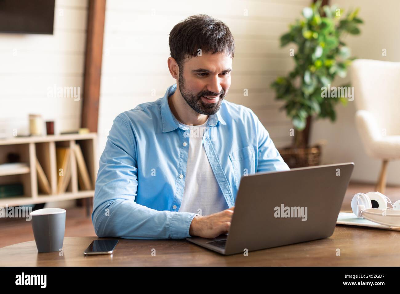 Businessman Using Laptop Computer at Table at Office Stock Photo
