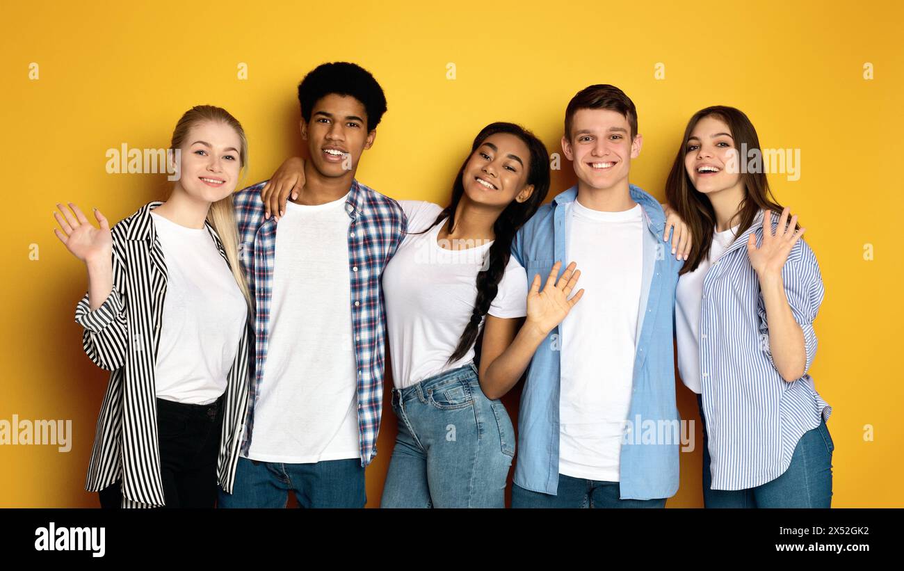 Group of Multiethnic Teenagers Standing Together, Waving at Camera Stock Photo