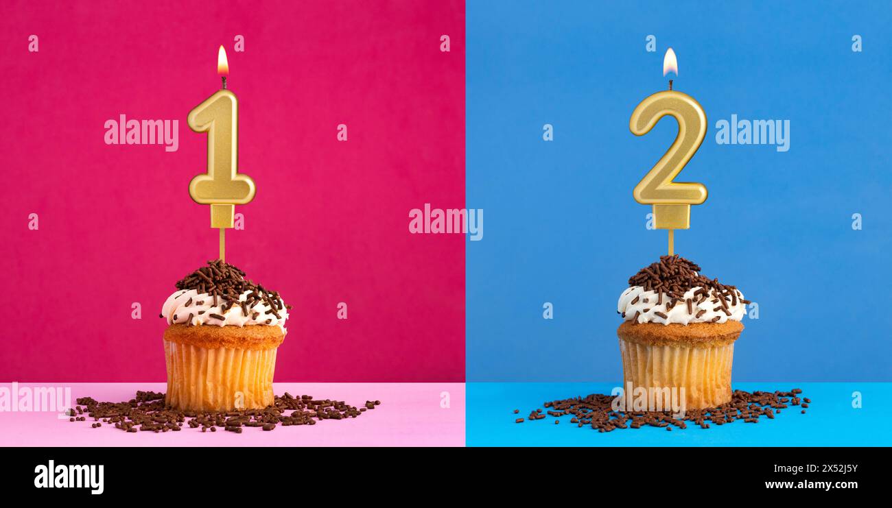 Two birthday cupcakes with the number 1 and 2 - Blue and pink background Stock Photo