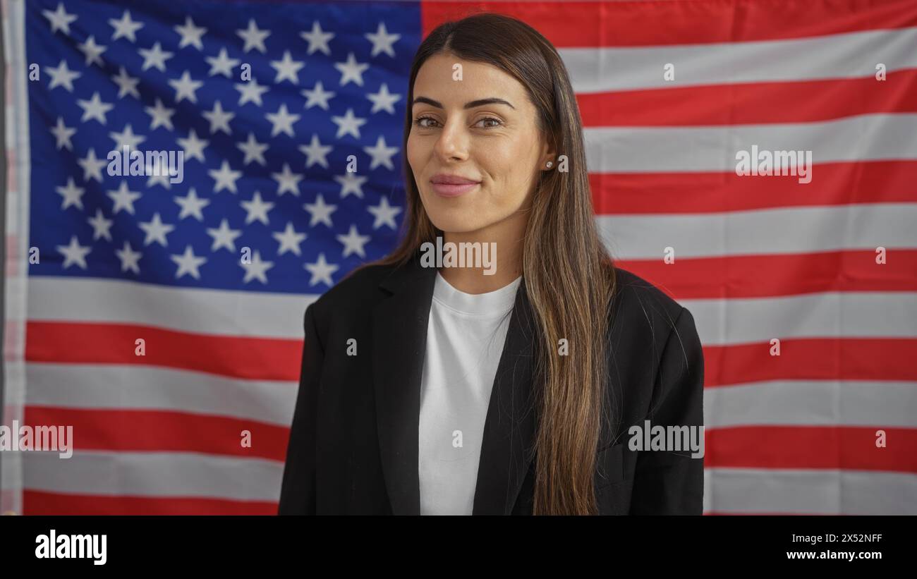 Portrait of a confident young hispanic woman in formal attire before an american flag Stock Photo