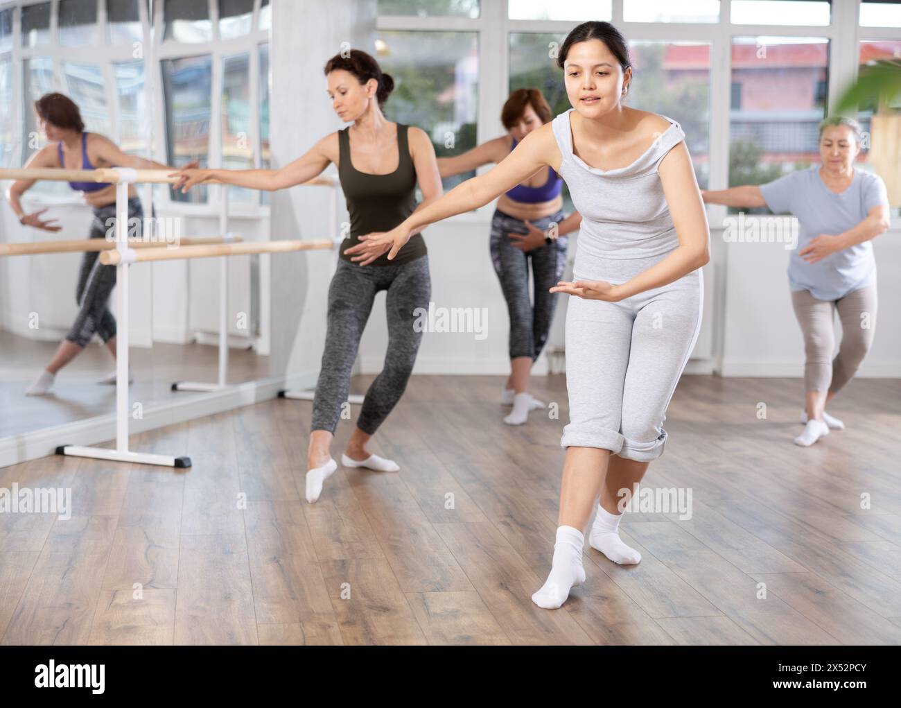 Group of female beginners rehearsing ballet dance Stock Photo