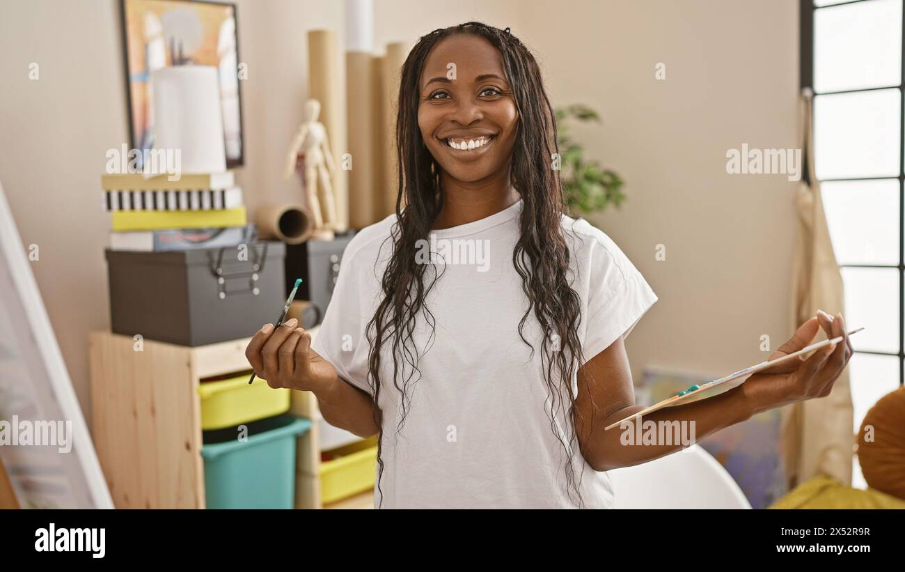 African american woman artist smiling in a creative studio interior ...