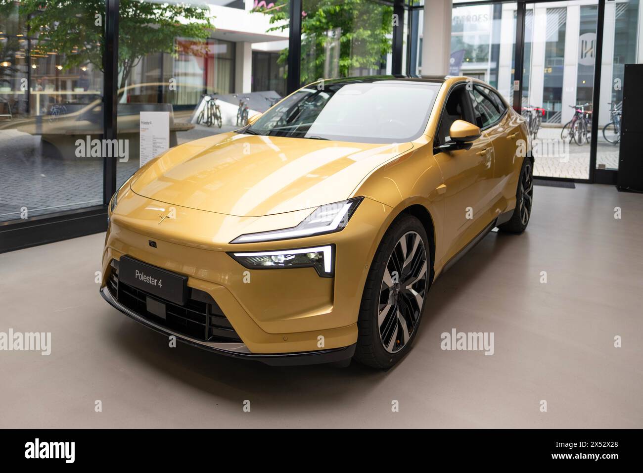 Shiny golden car Polestar 4 upcoming all-electric SUV coupe by Polestar, Volvo subsidiary, long-range, luxurious, eco-friendly vehicle showcased in sh Stock Photo